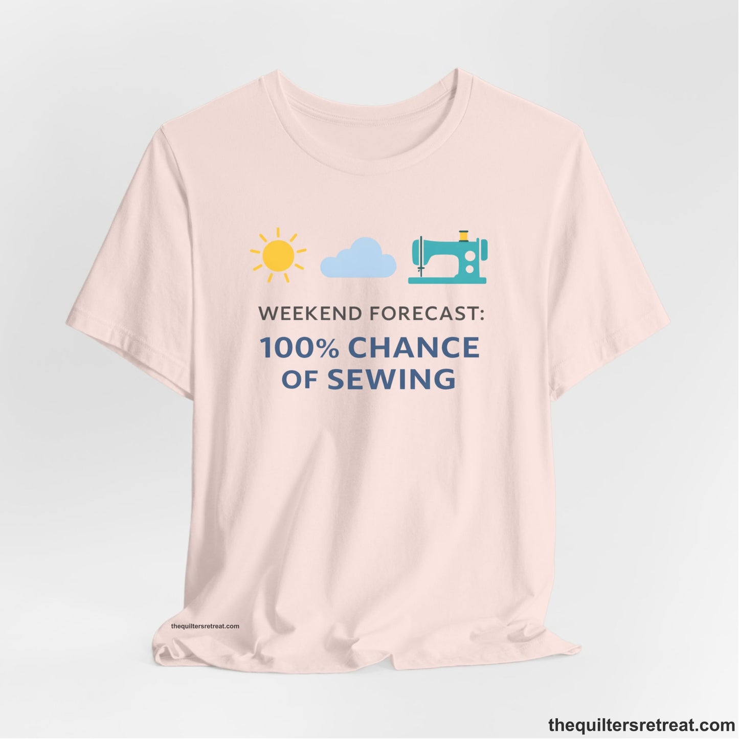 A Soft Pink Short Sleeve T-Shirt with a Sun, cloud, sewing machine icons; bold text "Weekend Forecast: 100% Chance of Sewing"; playful style.