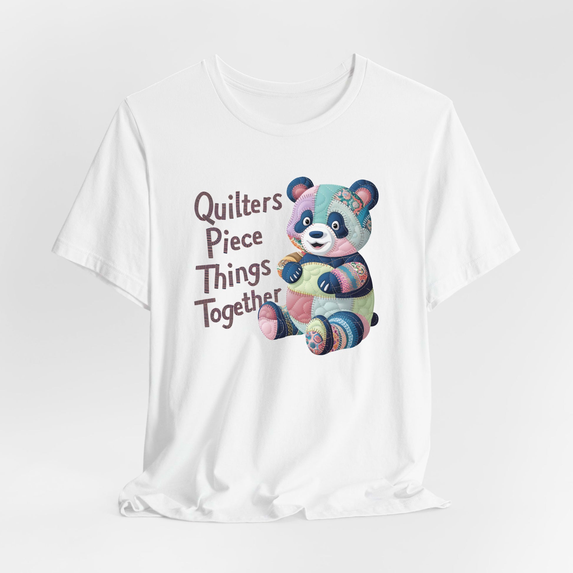 A White Short Sleeve T-Shirt with a patchwork panda with "Quilters Piece Things Together" text in a whimsical style