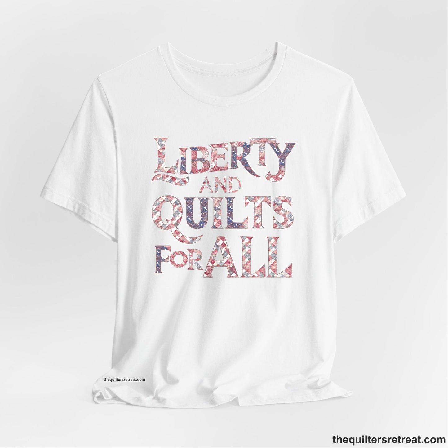A White Short Sleeve T-Shirt with a Liberty and Quilts for All" text with patchwork quilt pattern in a vintage style