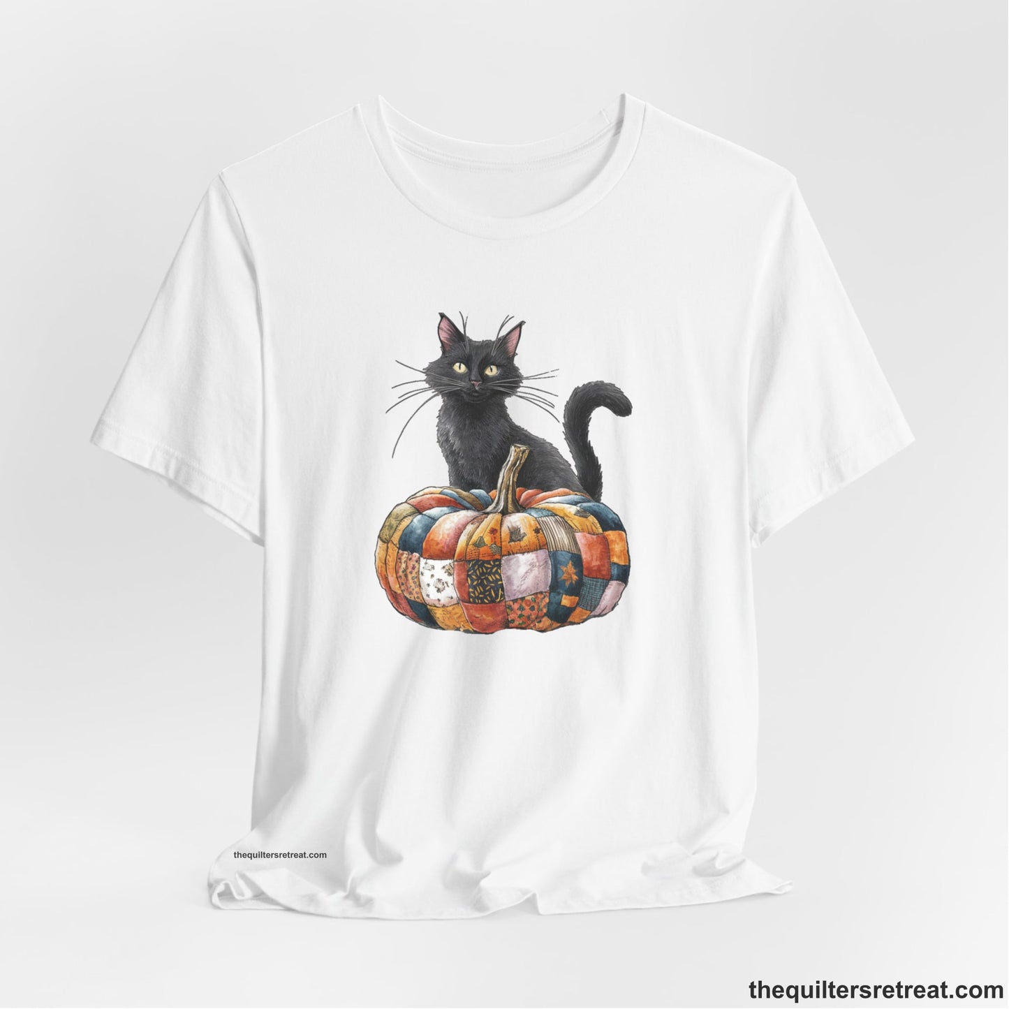 A White Short Sleeve T-Shirt with a black cat with a quilted patchwork pumpkin in a whimsical autumn style