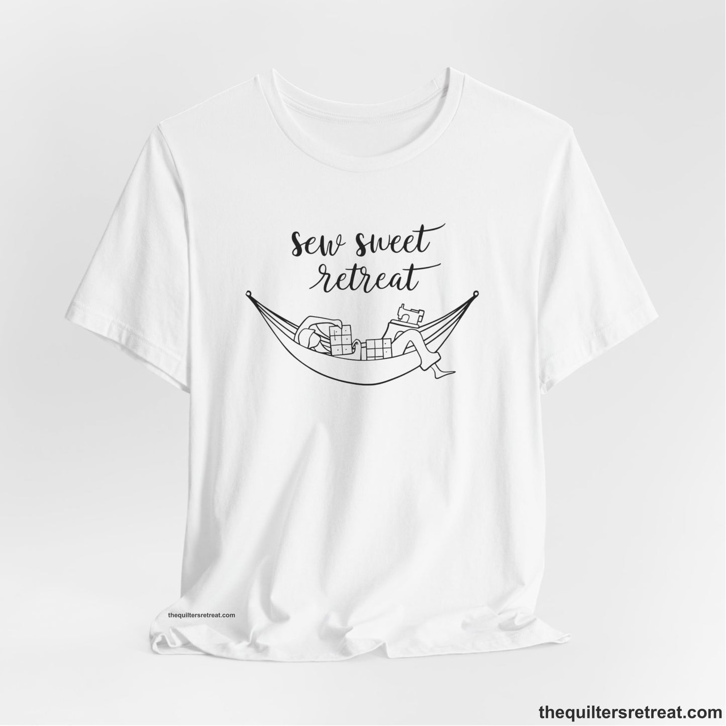 A White Short Sleeve T-Shirt with a sewing machine and thread spools with "Sew Sweet Retreat" in whimsical script