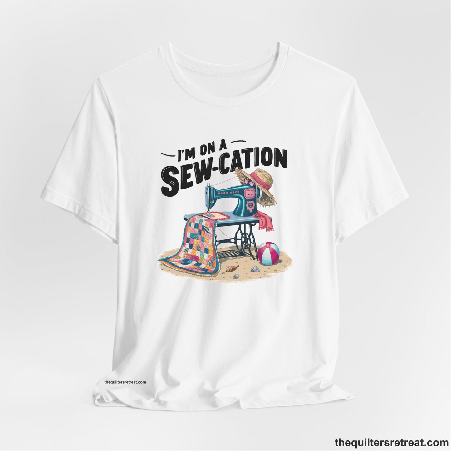 A White Short Sleeve T-Shirt with a vintage sewing machine with colorful quilt, beach items, and "I'm On A Sew-Cation" text
