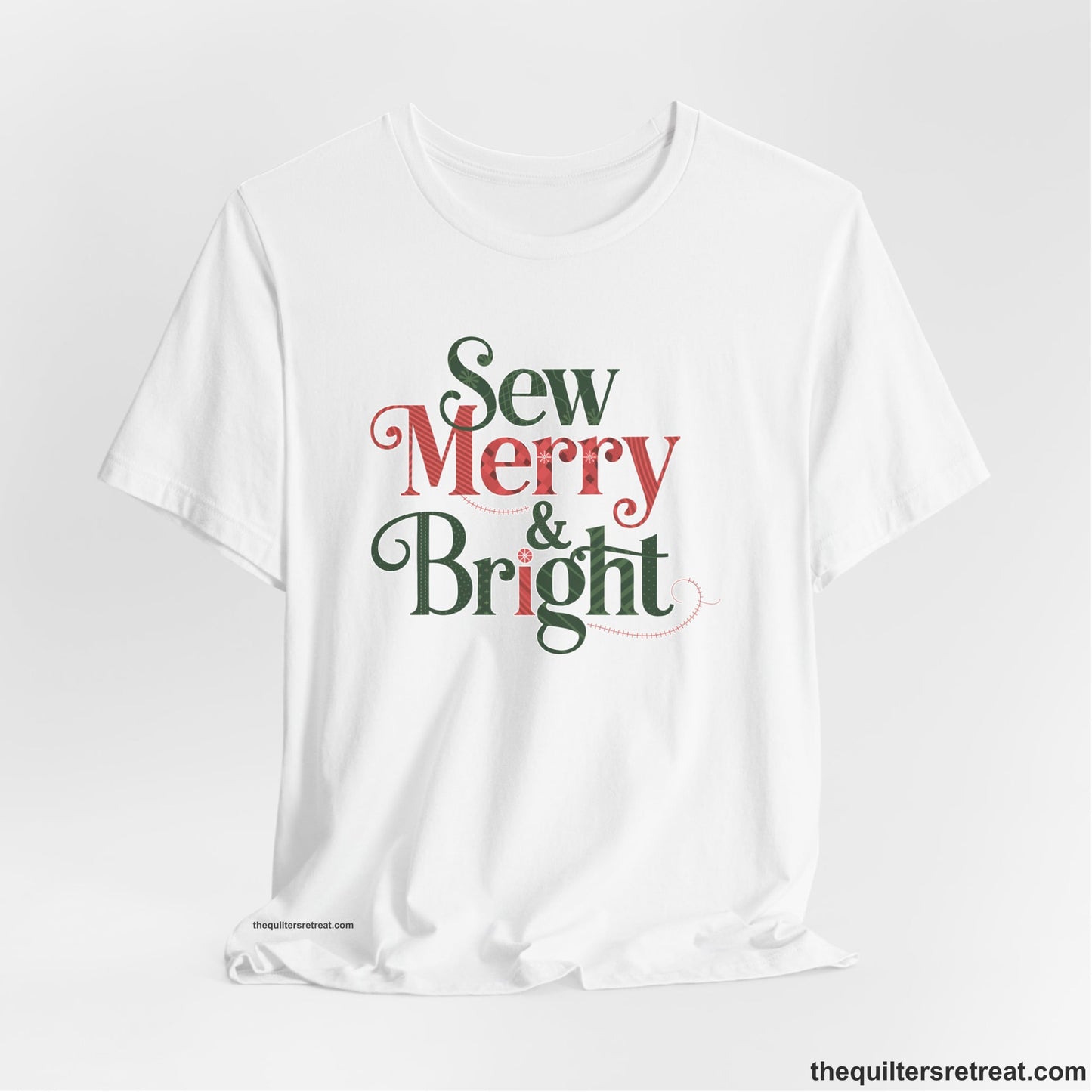 A White Short Sleeve T-Shirt with a festive "Sew Merry & Bright" text with decorative holiday patterns