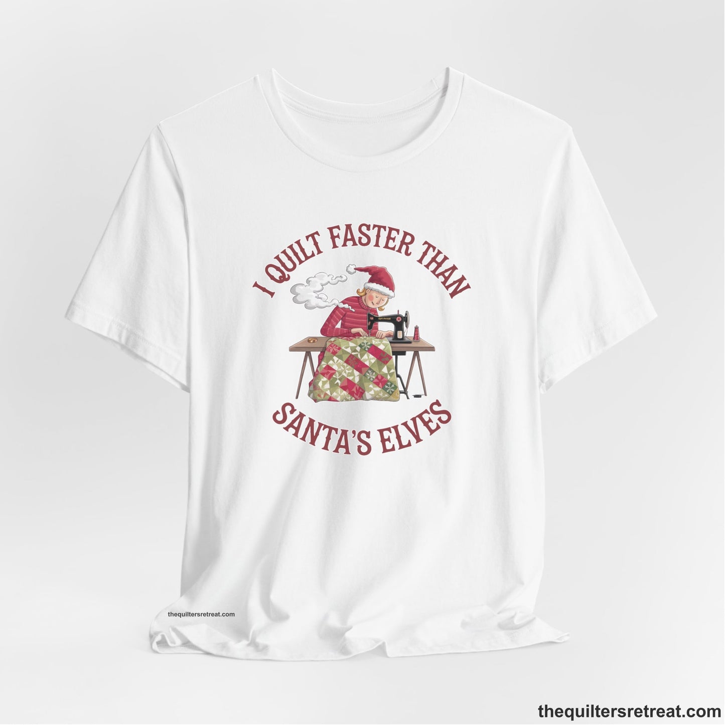 A White Short Sleeve T-Shirt with a whimsical illustration of a quilting woman with "I Quilt Faster Than Santa's Elves" text