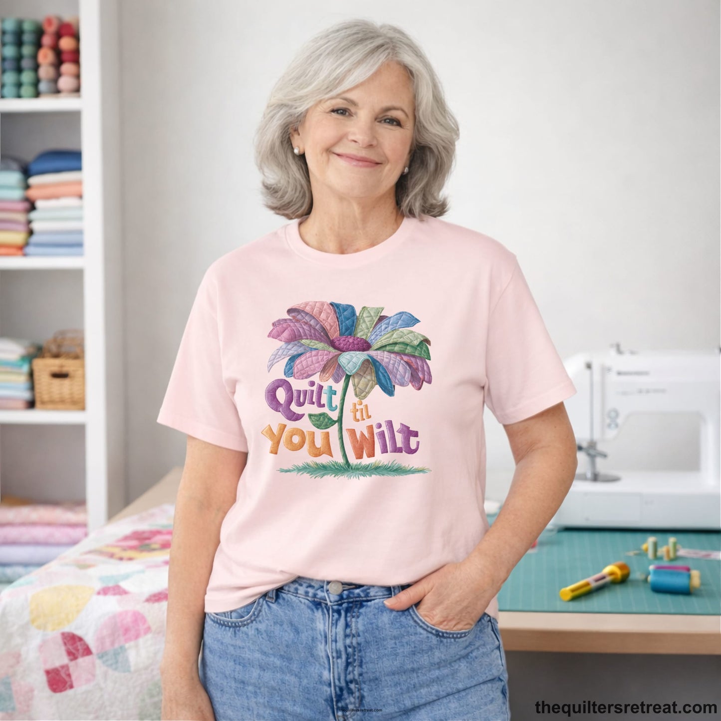 A Soft Pink Short Sleeve T-Shirt with a whimsical quilted flower with bold "Quilt til You Wilt" text