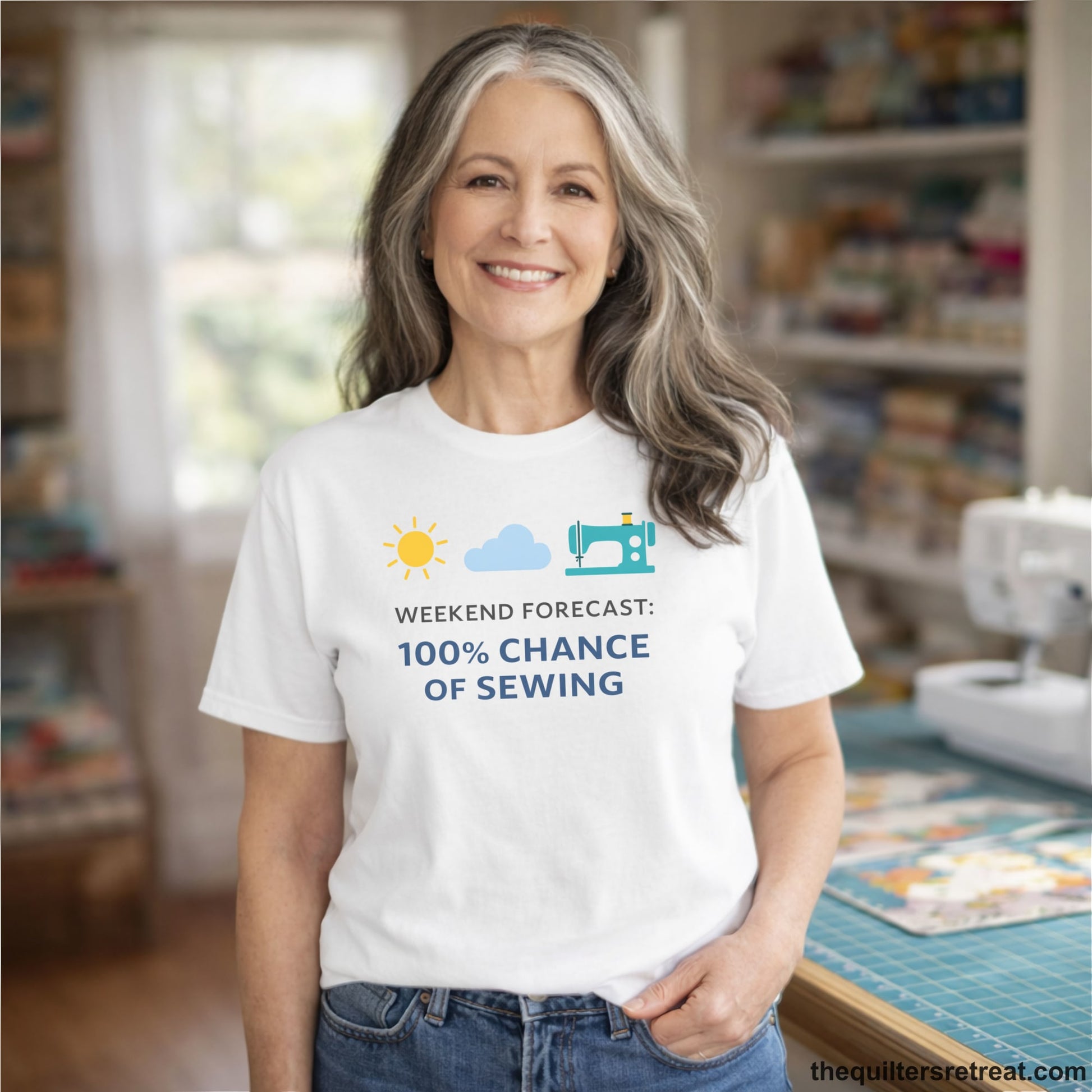 A White Short Sleeve T-Shirt with a Sun, cloud, sewing machine icons; bold text "Weekend Forecast: 100% Chance of Sewing"; playful style.